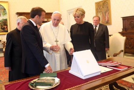 Pope Francis exchanges gifts with Emmanuel and Brigitte Macron in the Apostolic Palace.