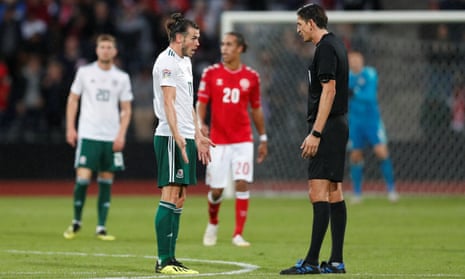 Gareth Bale protests with referee Deniz Aytekin after he awards a penalty to Denmark.