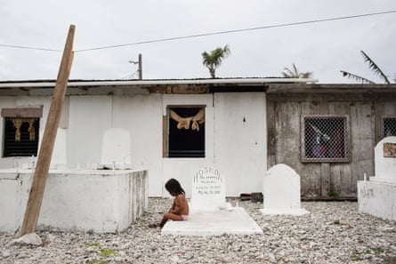 A child plays in a cemetery on Majuro, the capital of the Marshall Islands. With the increase of flooding, some cemeteries on the island are being washed out to sea.