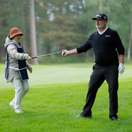 Wayne Perske, a 49-year-old from Brisbane, Australia, who played at the 2006 Open Championship at Hoylake before a severe spinal condition put him in hospital, is handed a club by his wife Vanessa