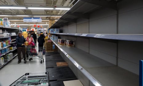 Customers looking for toilet paper find empty shelves, at a supermarket in Taipei