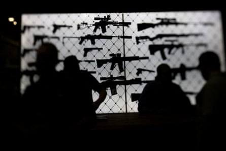 people in front of rifles