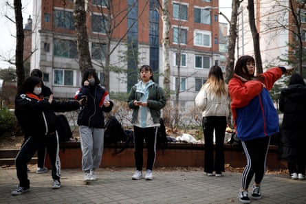Nao Niitsu, a college freshman from Tokyo, who wants to be a K-pop star, and other Japanese children warm up for an audition at a park in Seoul