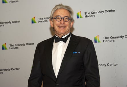 An older man with long gray hair in a tuxedo.