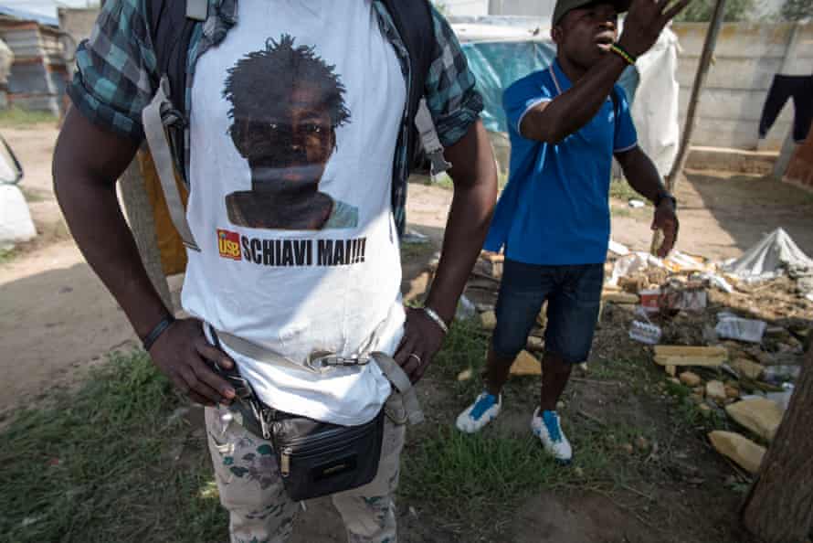 A resident wearing a t shirt comemerating Sacko Soumalya who was shot in the head collecting waste metal.
