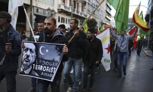 Kurdish demonstrators holding placards march during a protest against the Turkish president’s Athens visit.
