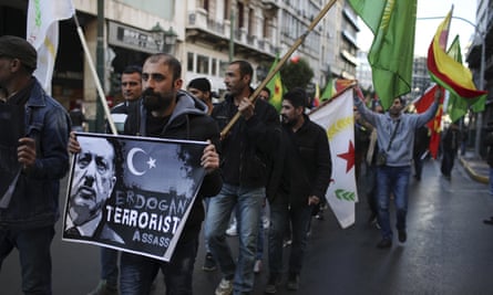 Kurdish demonstrators holding placards march during a protest against the Turkish president’s Athens visit.