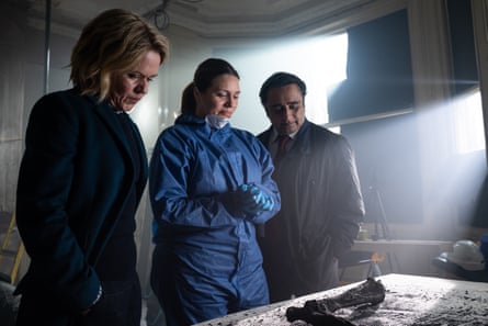 DCI Jessica James and DI Sunny Khan inspect charred human remains with Dr Leanne Balcombe (Georgia Mackenzie).