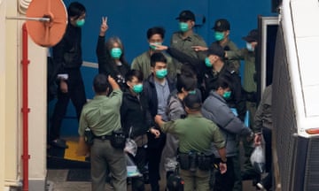 File image from March 2021 showing some of the 47 pro-democracy activists being escorted by Hong Kong security officials. Verdicts in some of the cases are due to be handed down from Thursday.