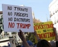 A sign reading 'No Trump' is held aloft at a protest in Madrid