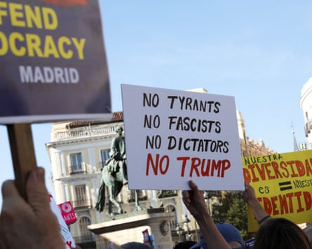 Protestors hold signs against U.S. President Trump during a ‘No Kings’ rally at Puerta del Sol in Madrid