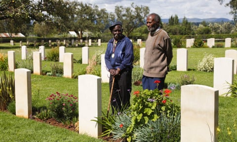 Eusebio Mbiuki and Gershon Fundi, two veterans of Britain’s King’s African Rifles, pay their respects to fallen comrades at a war graves cemetery near Mount Kenya.