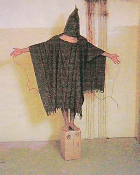 a hooded and wired Iraqi prisoner in the Abu Ghraib prison.