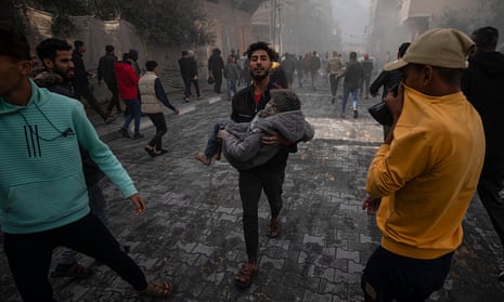 A man carrying an injured child after Israeli airstrikes on Rafah in the southern Gaza Strip on Monday.