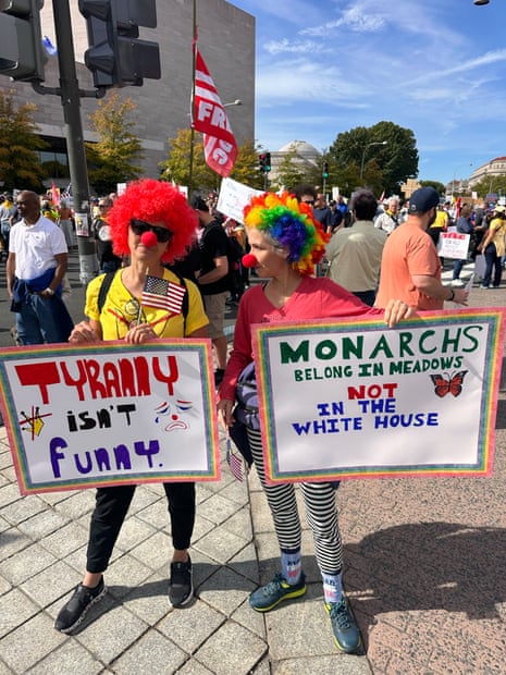 People hold signs at the “No Kings” Washington DC protest.