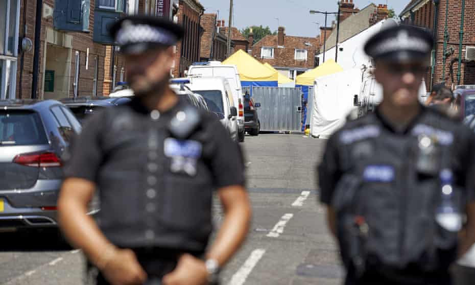 Police officers stand guard at a cordon near Rollestone Street in Salisbury: an officer is now in hospital for tests over potential novichok exposure.