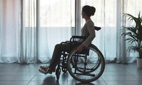 Silhouette of woman in wheelchair at home
