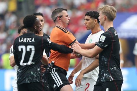 Referee Michael Oliver steps in to separate Hakimi and Laryea