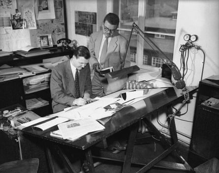 two men work in a newspaper office