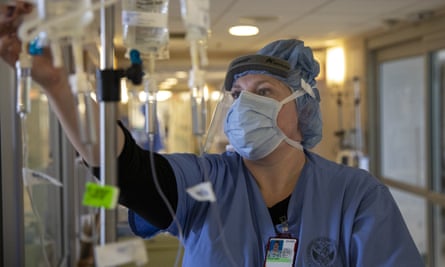 A nurse adjusts intravenous drug dosages being given to a Covid-19 patient at the Veterans Affairs medical center on 21 April 2020 in New York City.