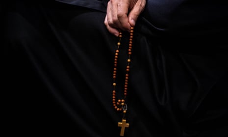 Hand grasping a rosary