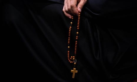 a rosary against black cloth