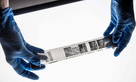 A museum worker examines the negatives.