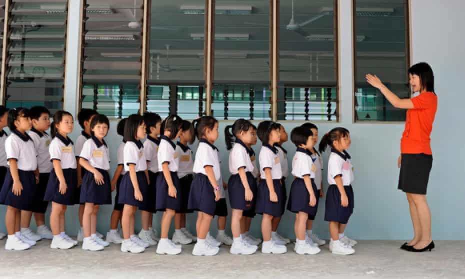 A teacher at Cantonment primary school getting her Primary one pupils to line up on the first day of the school term.