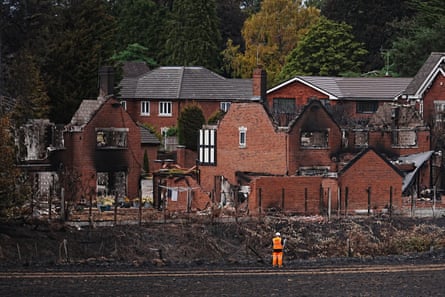 Network rail workers inspecting the track near homes destroyed by the Stourbridge wildfire.