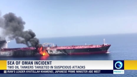 Still image taken from a video appears to show two tankers at sea, one of which has a large plume of dark smoke in the Gulf of Oman