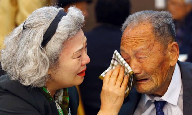 South Korean Lee Jung-sook wipes the tears from her North Korean father Lee Heung-jong at the end of their reunion in 2015