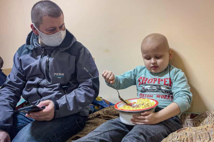 Vyacheslav Krot watches his son Vlad, 6 have his meal in the oncology departement.