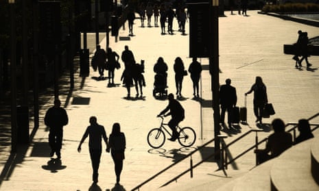 People are silhouetted against the late summer sun in Liverpool city centre last month.