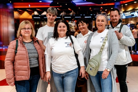 Bea in the cinema foyer with her friends and making a statement with Tisza party logos