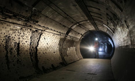 A worker passes through part of the disused Down Street underground station in London.