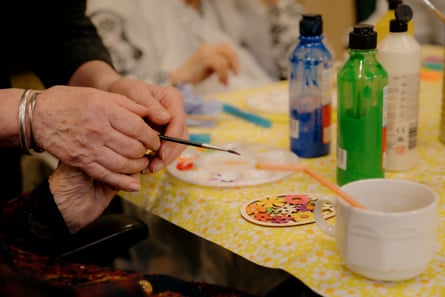 Assisting with painting in an art class