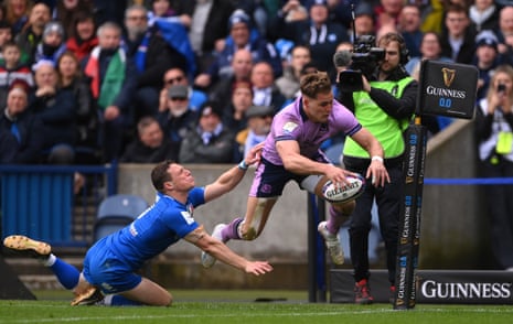 Duhan van der Merwe of Scotland scores the team’s first try whilst under pressure from Paolo Garbisi of Italy.