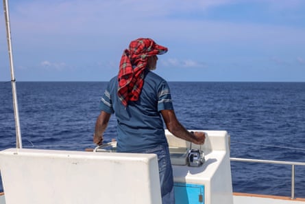 Ibrahim Hamid at the helm of a boat