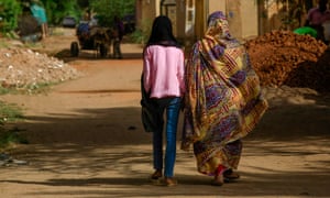 A girl and a woman walk