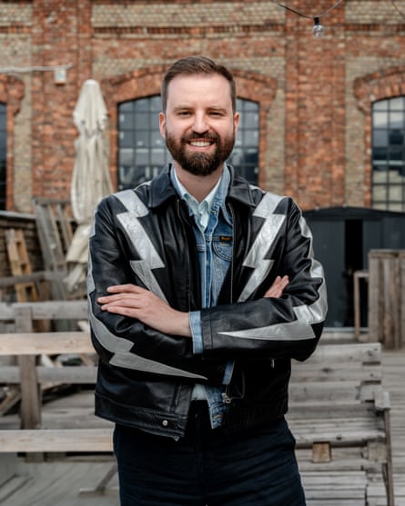 Márton Gulyás smiles with arms folded.