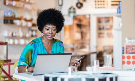 Black business owner at her laptop in her shop.