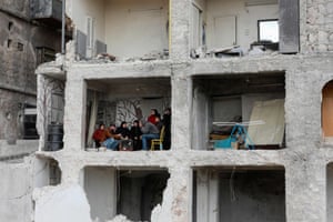 Aleppo, Syria. A family drink coffee in the remains of their home, in a building damaged by the earthquakes