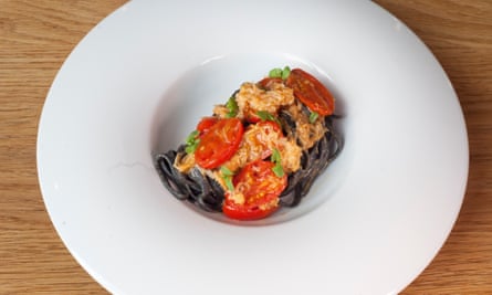 Crab linguine on a large round white plate.