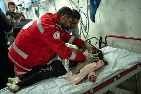 Medics attend to a Palestinian girl wounded in Israeli bombardment in Khan Younis.