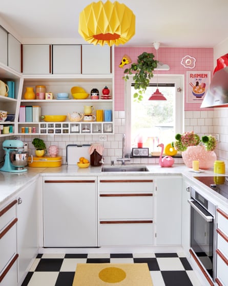 Candy crush: The pink-and-white-tiled kitchen with checkered floor and colourful cookware.
