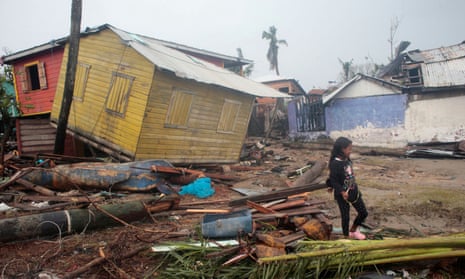 A girls walks past houses destroyed by Hurricane Iota, in Puerto Cabezas, Nicaragua.