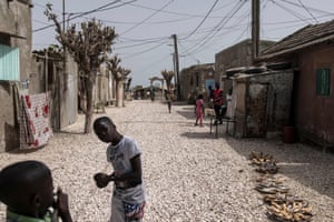 Children play along a road of clam shells