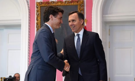 Canadian Prime Minister Justin Trudeau shakes hands with Minister of Finance Bill Morneau 