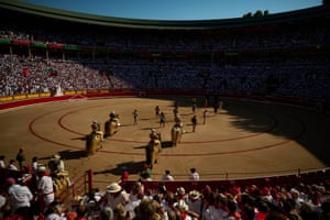 Bullfighters enter an arena