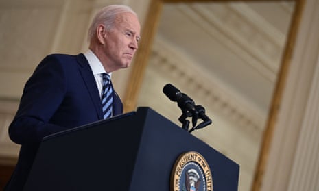 Joe Biden stands at a podium bearing the presidential seal.